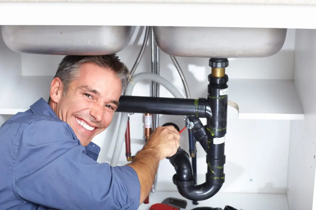 bigstock-Young-plumber-fixing-a-sink-at-19547801-min