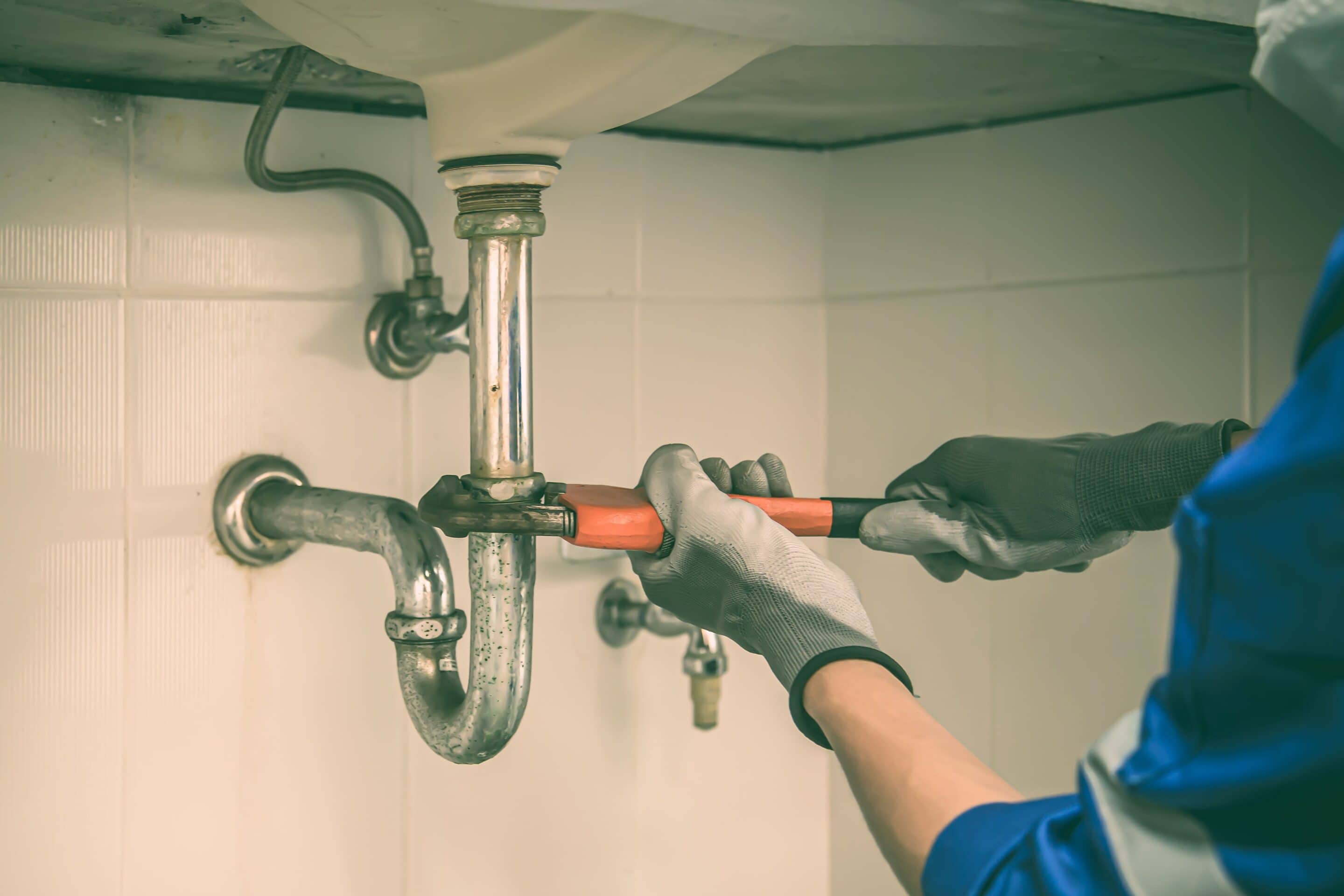 plumber using a wrench