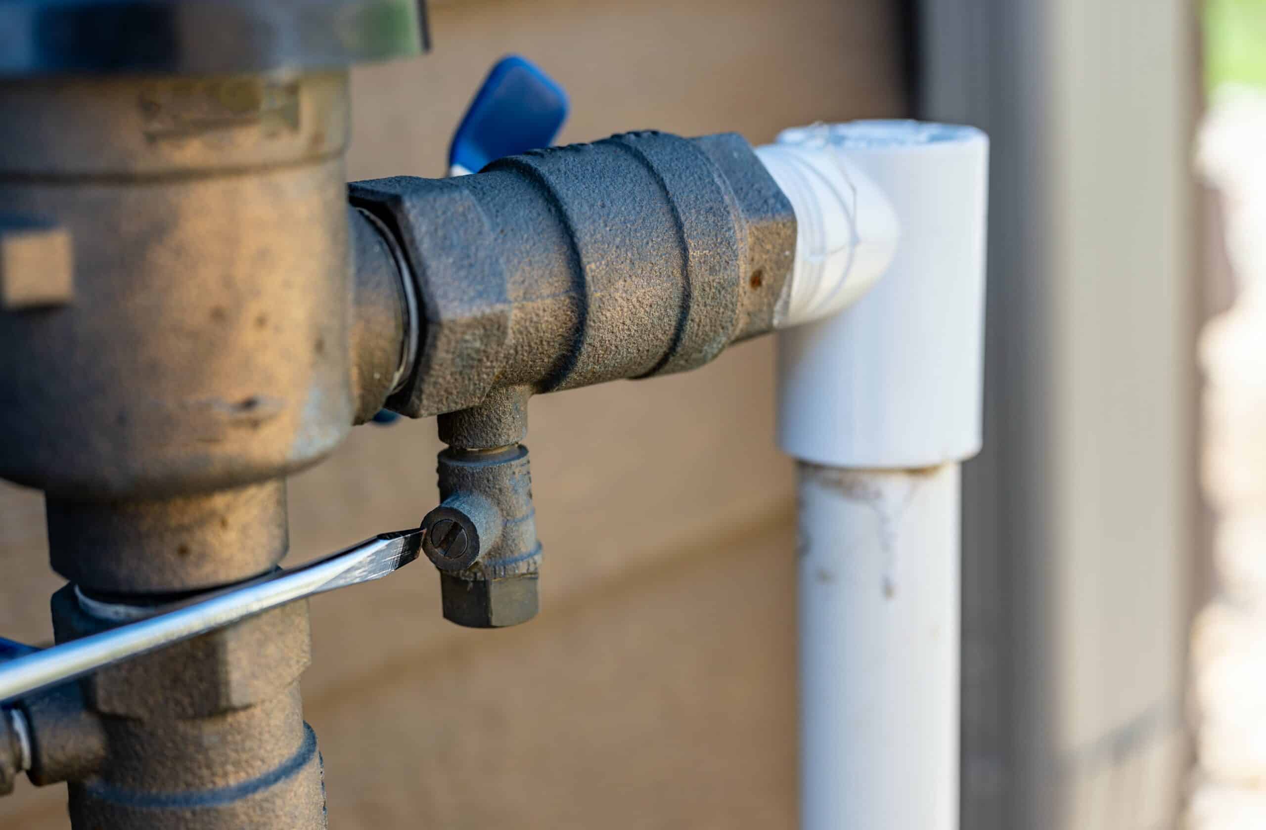 plumber fixing a backflow